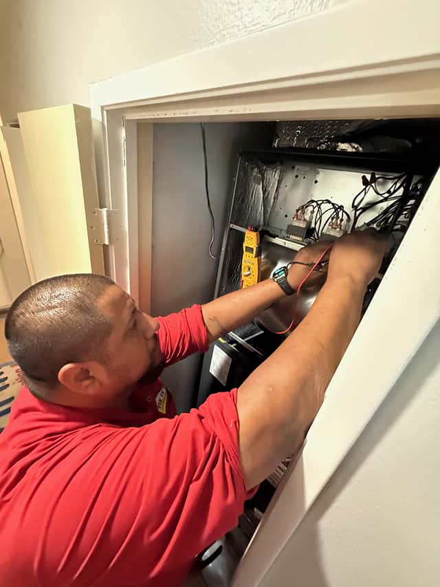Fix It Fast technician Jaime working on a furnace in Simi Valley, CA.